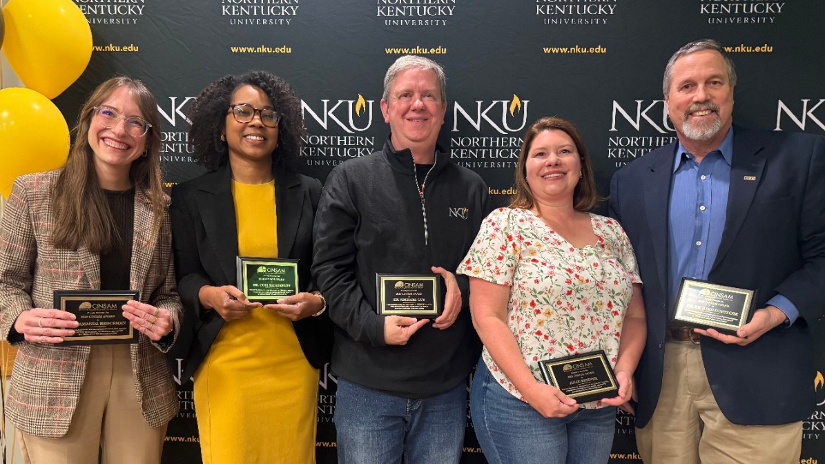CINSAM Award winners pose for a picture with their plaques