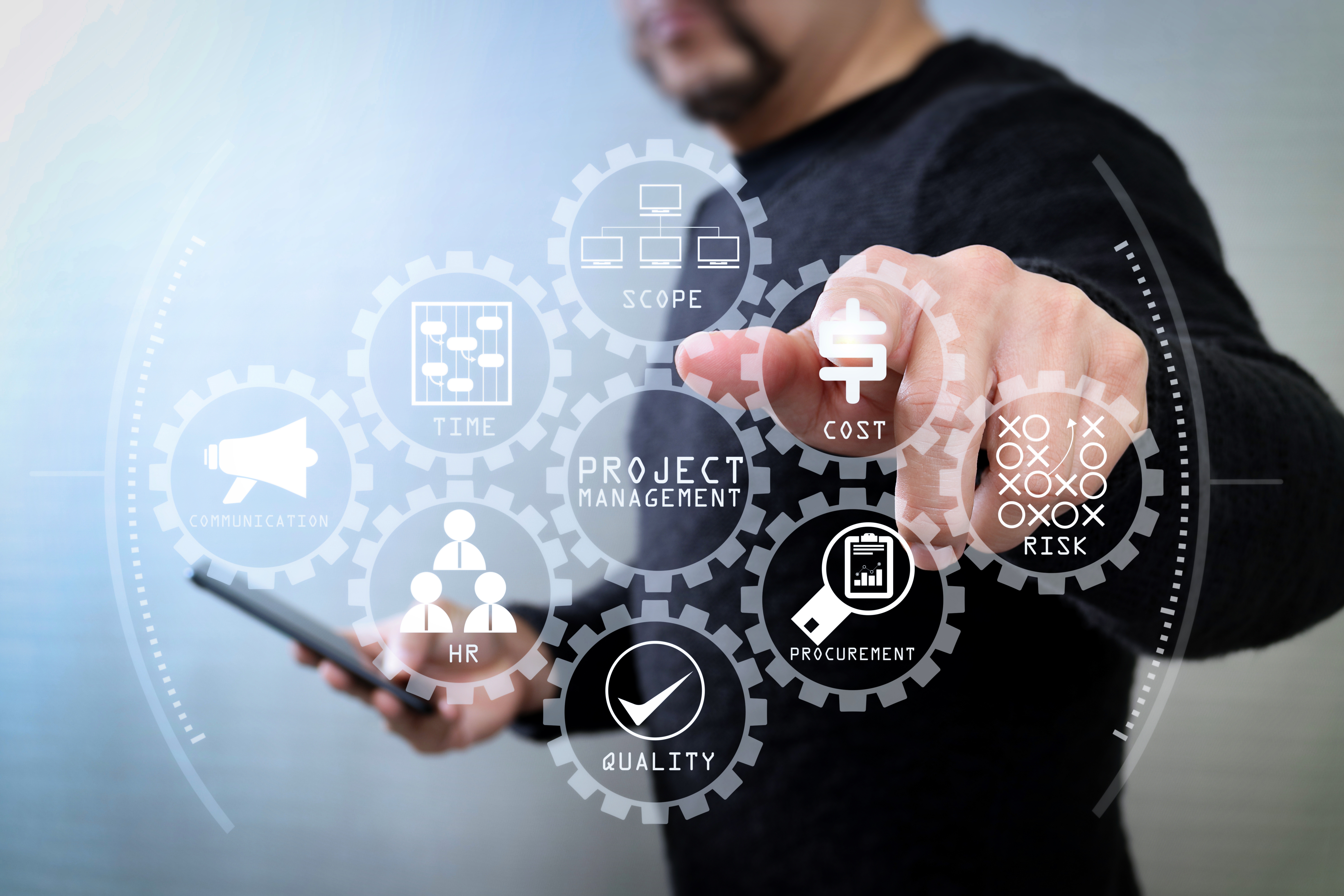 Man pointing at symbols representing aspects of project management